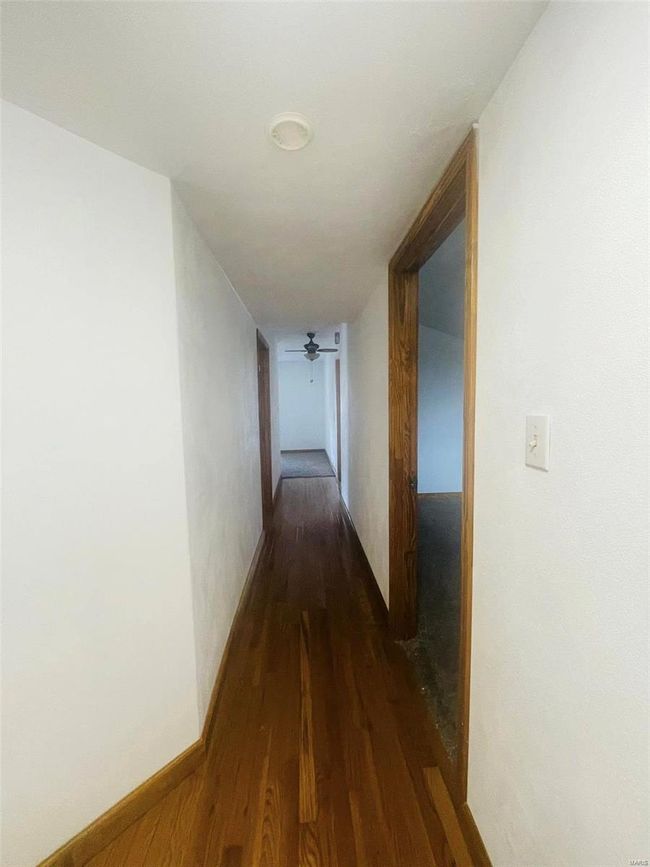Hallway with dark wood-type flooring | Image 12