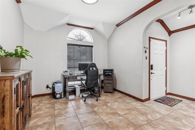 Office space featuring vaulted ceiling, baseboards, and arched walkways | Image 16