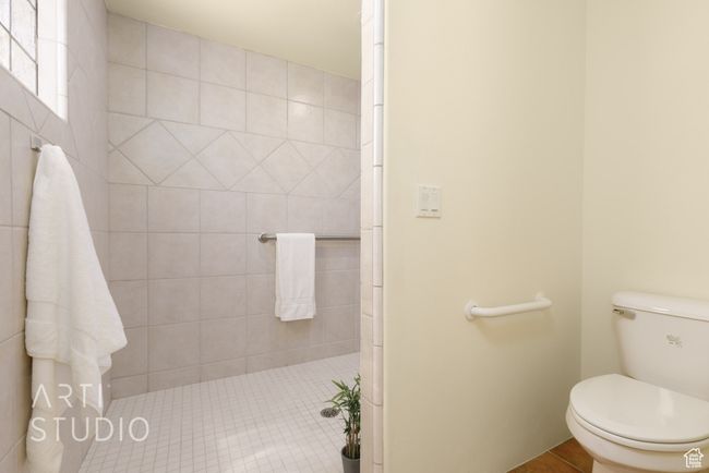Full bathroom with tile patterned flooring, a tile shower, and toilet | Image 30