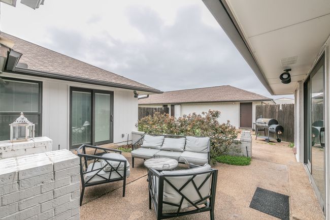 Unit 4900 View of private patio / terrace with an outdoor living space looking towards 2 car garage | Image 21