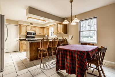 The kitchen is open to the dining area, making conversation easy. | Image 2