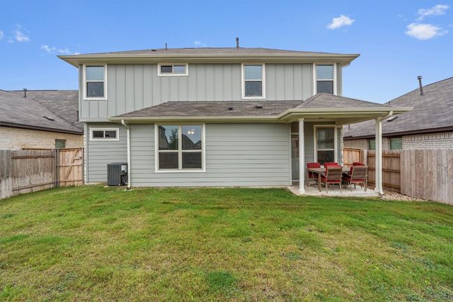 Back of house with board and batten siding, a patio area, and central air condition unit | Image 33