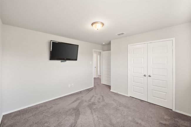 Unfurnished bedroom with carpet floors, baseboards, a closet, and visible vents | Image 10