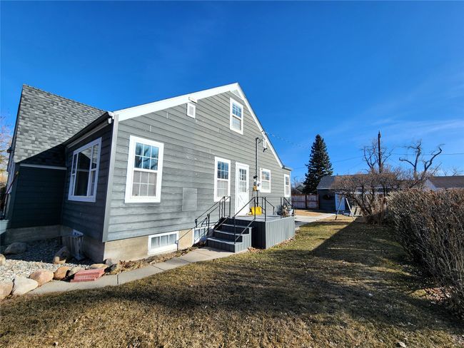 Back of property featuring a shingled roof and fence | Image 4