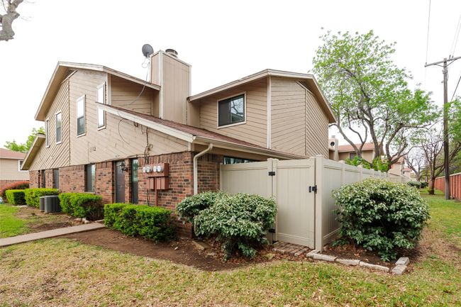 Back of property with a chimney, a gate, brick siding, fence, and a lawn | Image 22
