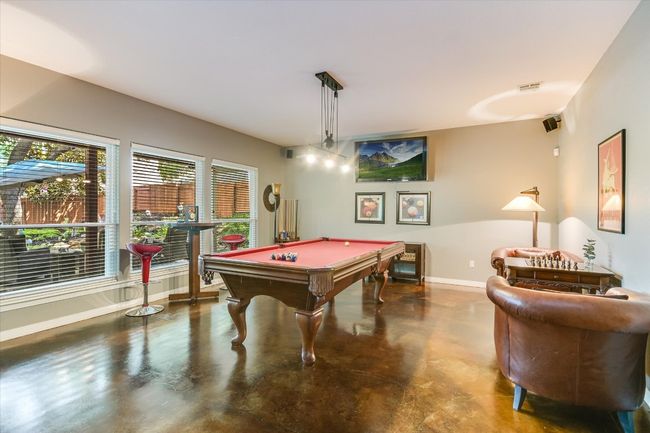 Recreation room featuring concrete floors, billiards, and baseboards | Image 14