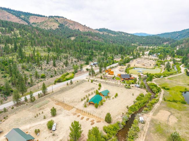 Aerial view of a heavily wooded area and a water and mountain view | Image 5