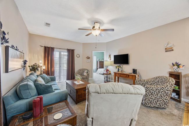 Living area with ceiling fan and light colored carpet | Image 14