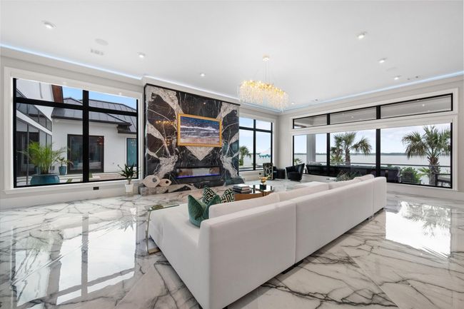 Living room with a premium fireplace, recessed lighting, marble finish floor, and visible vents | Image 6