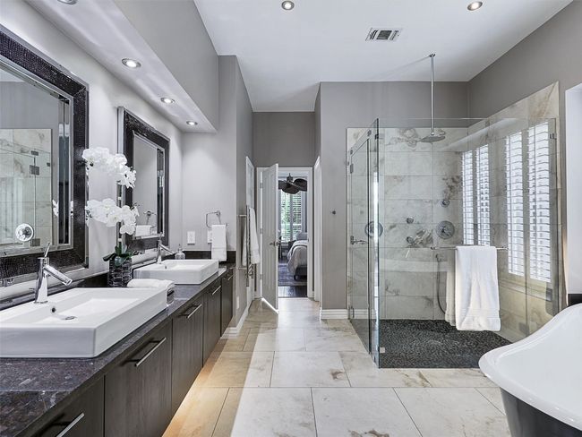 Bathroom featuring a stall shower, double vanity, recessed lighting, connected bathroom, and a freestanding tub | Image 28