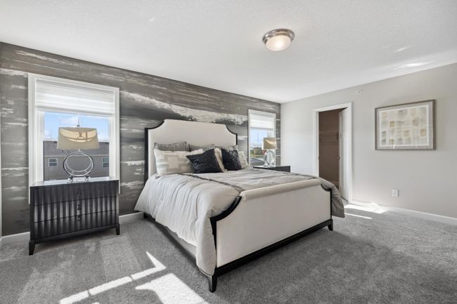(Photo of decorated model, actual home's finishes will vary) The owner’s suite is located on the second level, comprised of a restful bedroom, an en-suite bathroom and a spacious walk-in closet. | Image 14