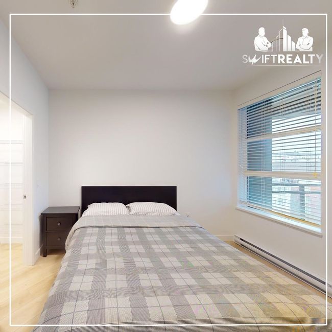 Bedroom featuring a baseboard heating unit, baseboards, and wood finished floors | Image 6