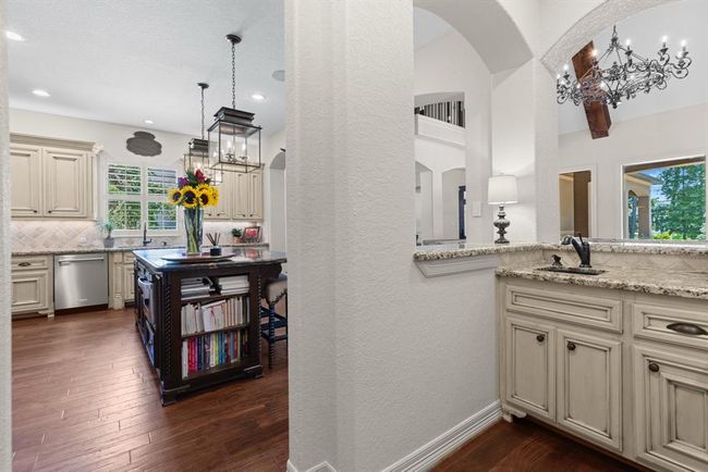 An entertainer's dream! The home itself has two separate wet bars downstairs. This first one off the kitchen makes for the perfect coffee bar as well. It services the den, which is open to the kitchen and large breakfast area. This interconnected space creates a seamless flow and encourages conversation. | Image 20