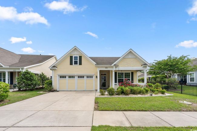 Craftsman-style home with a porch, a front lawn, concrete driveway, an attached garage, and fence | Image 32
