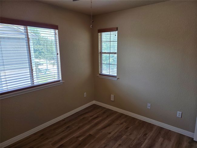 Unfurnished room with plenty of natural light and dark wood-style flooring | Image 31
