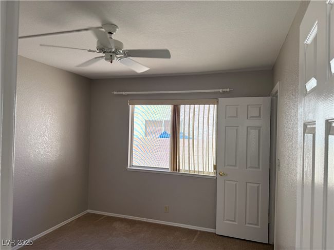 Empty room with dark carpet and a ceiling fan | Image 11