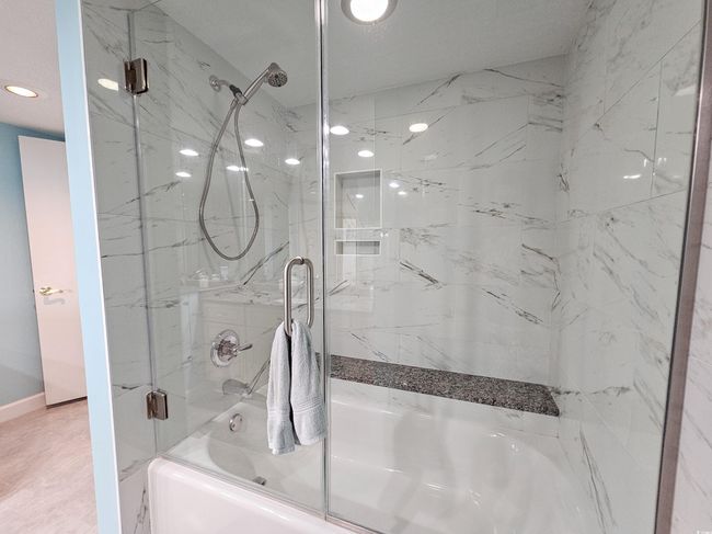 Full bathroom featuring combined bath / shower with glass door and recessed lighting | Image 26