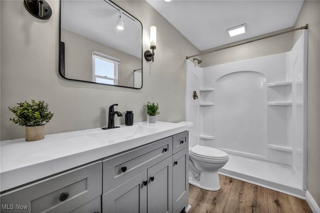 Bathroom with vanity, a shower, and wood finished floors | Image 33