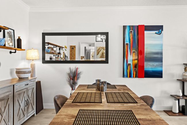 Dining area featuring baseboards, light wood-style floors, and crown molding | Image 8