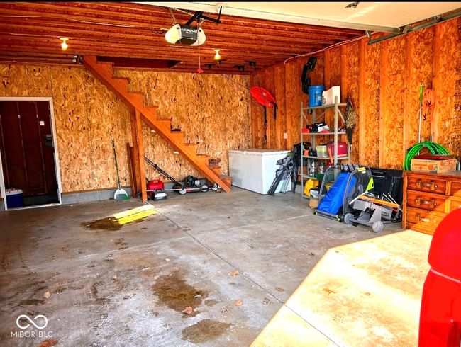 Inside 2 car garage with stairs to storage | Image 30