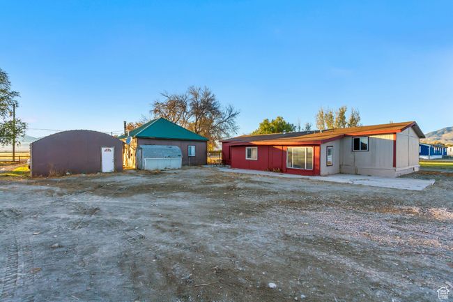 View of the back of the West home and the back of the Eat home with an additional outbuilding | Image 18