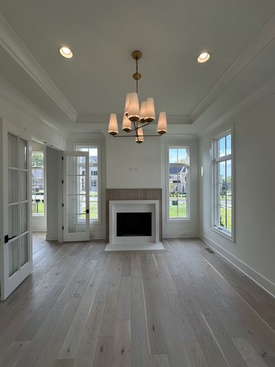 Spacious Study with French doors, wood-burning fireplace and lots of natural light. *this home is under construction photo taken 5/19/24 Photo updated 7/13/24 | Image 3