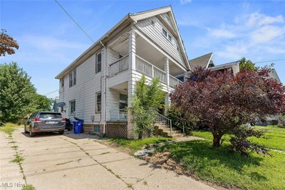 View of home's exterior with a balcony and covered porch | Image 2