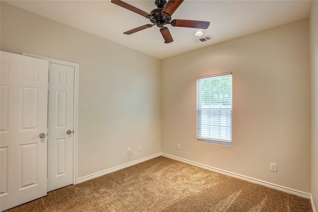 Carpeted spare room featuring a ceiling fan and recessed lighting | Image 24