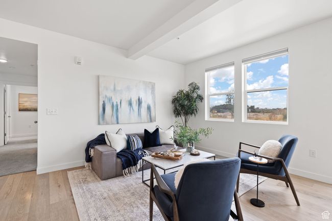 Living area featuring light wood finished floors and beam ceiling | Image 5