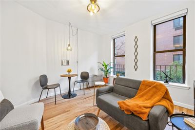 Living area with wood-type flooring | Image 3