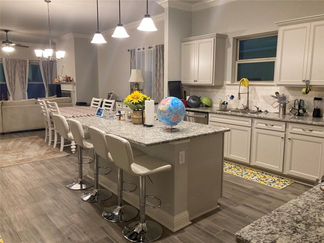 Kitchen with crown molding, a kitchen bar, and a sink | Image 5