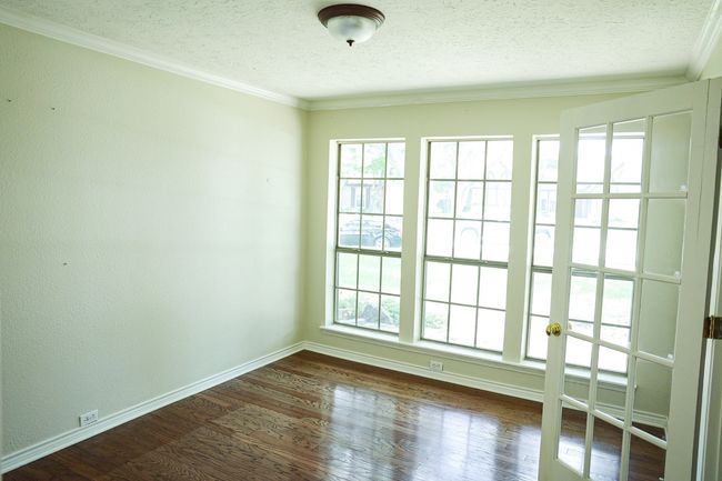 Spare room with a textured ceiling, ornamental molding, and dark wood-style floors | Image 17