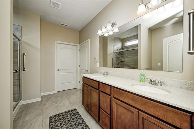 Master Bath, double sinks, Quartz counter tops, walk-in closet ahead and water closet to right | Image 17