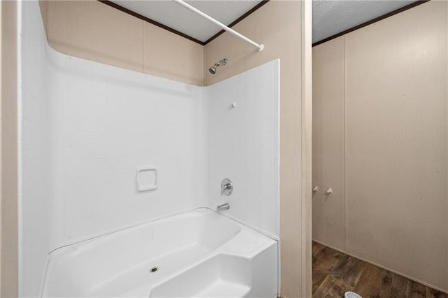 Full bathroom with wood finished floors and bathing tub / shower combination | Image 26