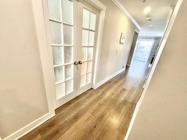 Hall featuring french doors, wood finished floors, and ornamental molding | Image 11