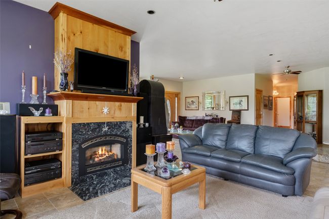Living room with a tile fireplace and ceiling fan | Image 40