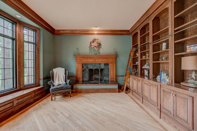 Utilize this space as your office to work from home or as a relaxing library with custom built-ins and beautiful millwork | Image 30