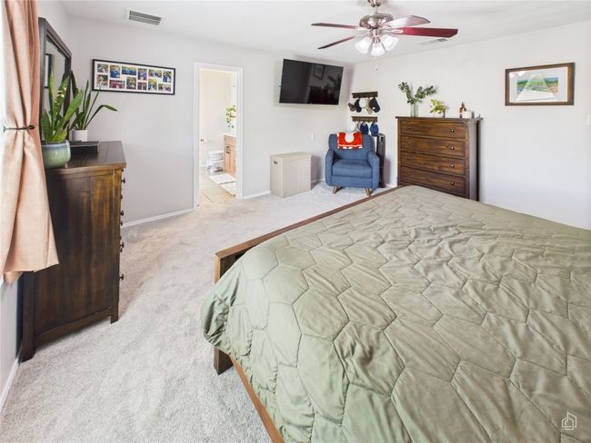 Bedroom with carpet, ensuite bath, and a ceiling fan | Image 12