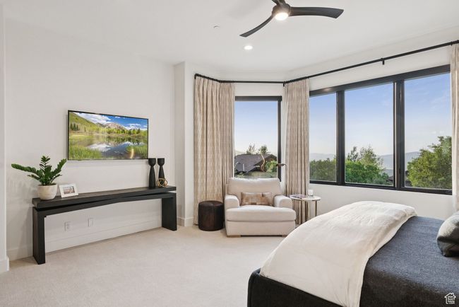 Carpeted bedroom featuring a ceiling fan | Image 59
