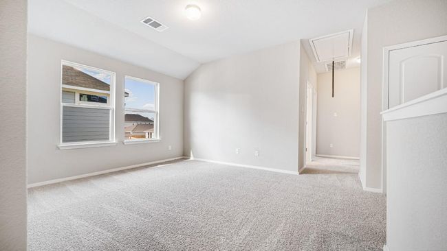 Spare room featuring attic access, carpet, and vaulted ceiling | Image 18