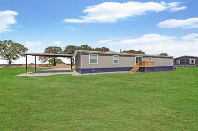 Rear view of property with a lawn and a carport | Image 2