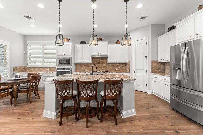 Kitchen with visible vents, appliances with stainless steel finishes, and backsplash | Image 9