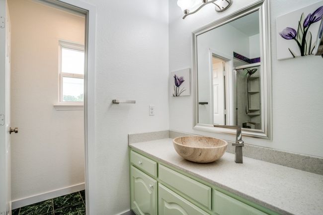 Bathroom featuring vanity, a shower, and baseboards | Image 24