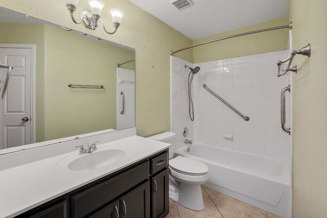 Full bathroom with vanity, tub / shower combination, and tile patterned floors | Image 22