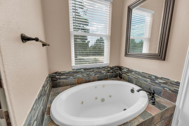 Bathroom with a whirlpool tub and a textured wall | Image 21
