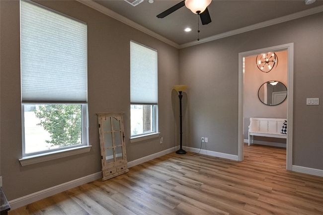 Bonus room featuring ceiling fan with notable chandelier, crown molding, and wood-type flooring | Image 28