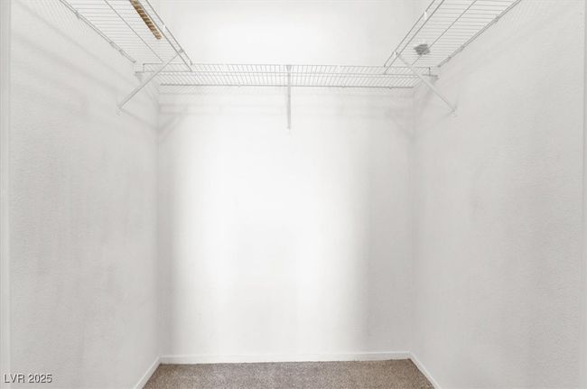 Walk in closet with light carpet | Image 16