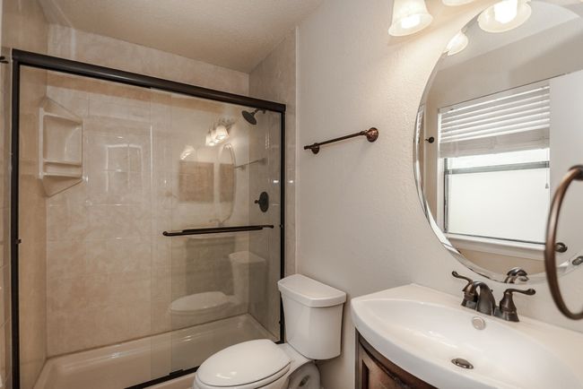 Bathroom with a shower stall, vanity, and a textured ceiling | Image 17