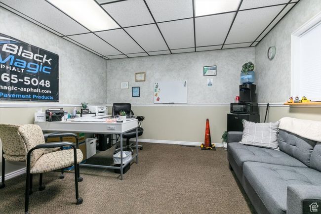 Carpeted office featuring a paneled ceiling | Image 11