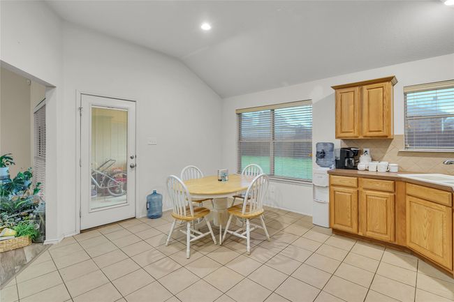 Dining area featuring lofted ceiling, light tile patterned floors, and recessed lighting | Image 12